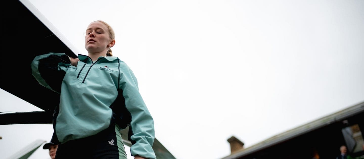 CUBC female athlete carrying boat