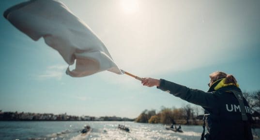 Umpire waving flag at crews